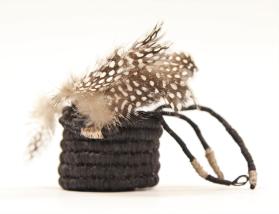 Basket with guinea hen feathers