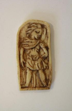 Bone panel with figure in relief