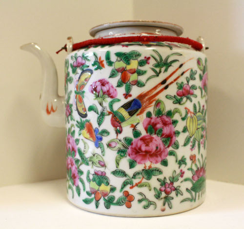 Teapot and lid in padded basket